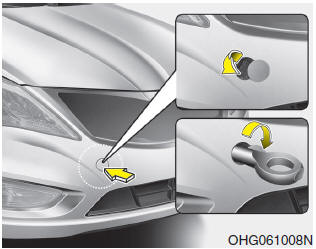 1. Open the trunk, and remove the towing hook from the tool case.